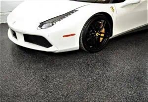 White sports car on a full flake epoxy and polyaspartic coated garage floor.